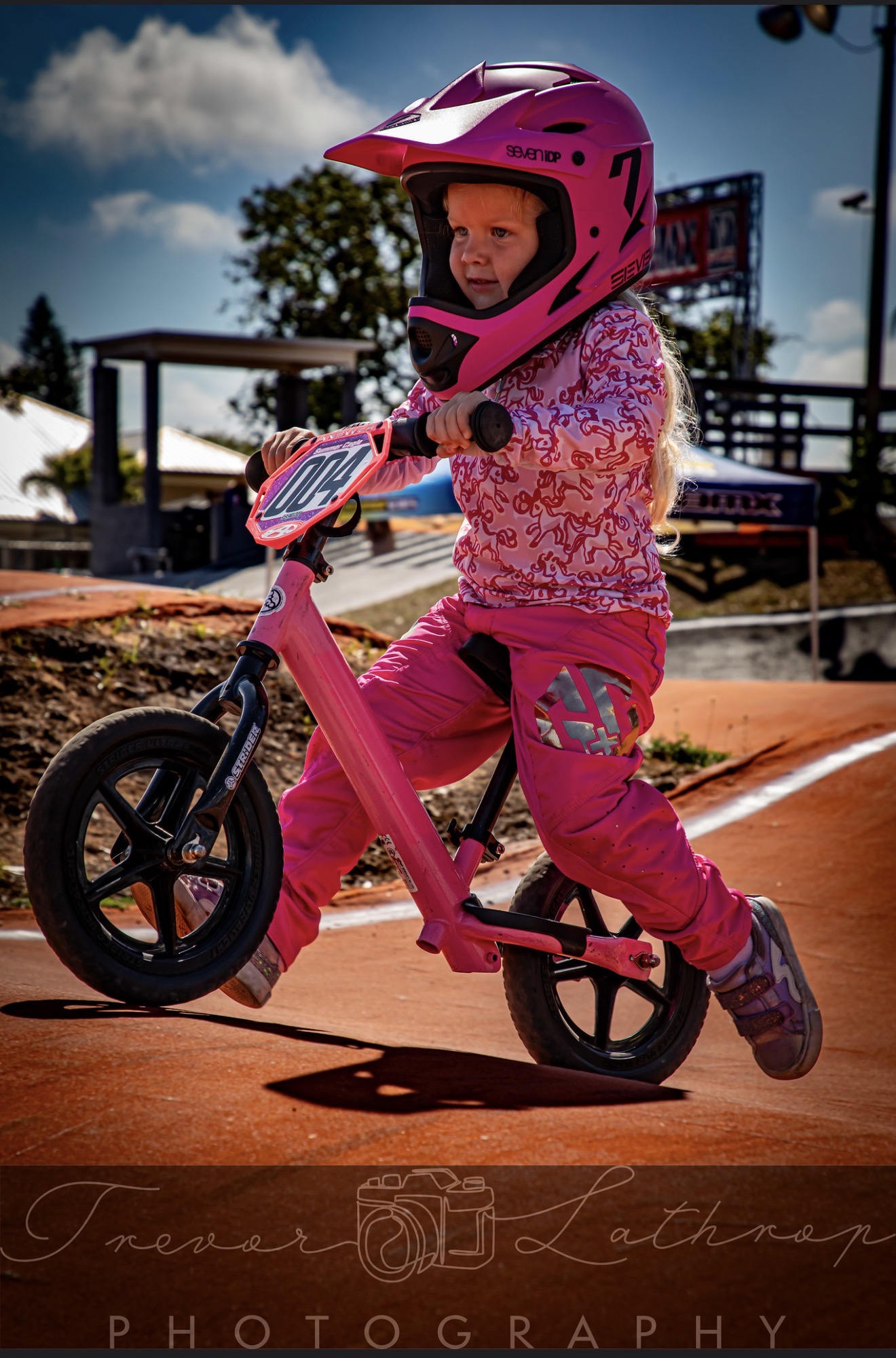 Summer Cagle balancing while standing on her pink BMX balance bike